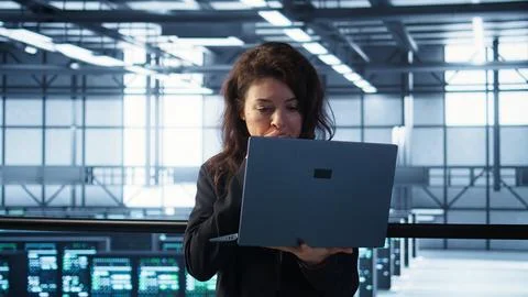 Server room worker under pressure to secure sensitive data after threat alert Stock Photos
