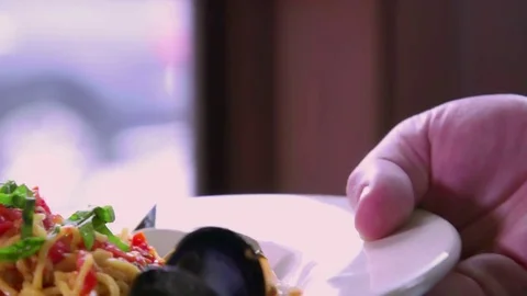 Server sets down Gourmet Pasta dish Stock Footage 75759689