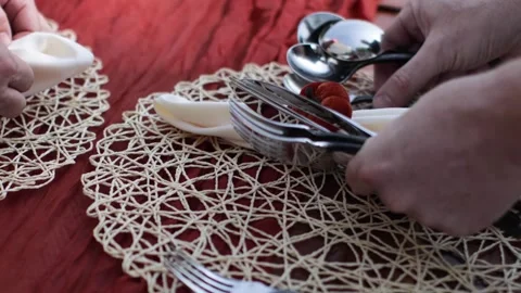 Server setting a table for a fall themed dinner outdoors Stock Footage 317602343