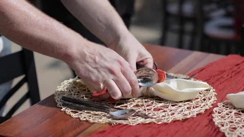 Server setting a table for a fall themed dinner outdoors Stock Footage 317602348