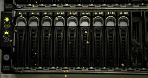 Server storage array displaying drive caddies with LED lights in data center  写真素材
