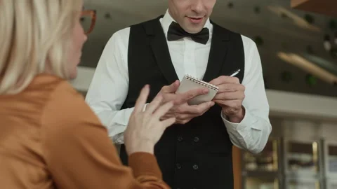 Server Taking Order from Blonde Female Guest in Luxury Restaurant Stock Footage 309010953