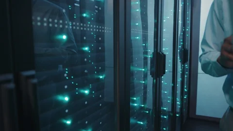 Server technician specialist working on laptop computer running diagnostics on Stock Footage 119081965