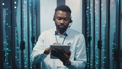 Server technician using digital tablet in modern rack server room. Portrait of Stock Footage 119081798