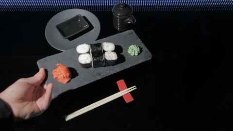 Serves sushi Maki with shrimp on the table. On the table is a black plate Stock Footage 87012292