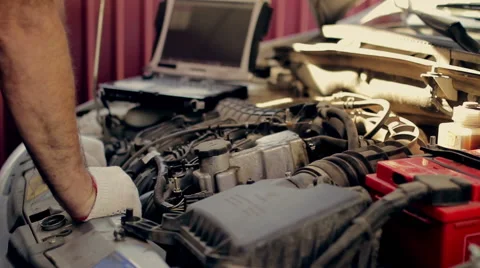 Service and repair, computer  diagnostics: a mechanic check the car for faults Vídeos de archivo 55562513