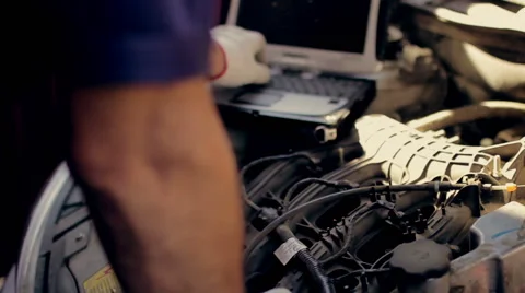 Service and repair, computer diagnostics: a  mechanic check the car for faults 動画素材 56059716