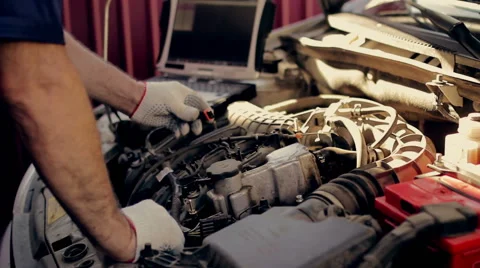 Service and repair, computer diagnostics: a mechanic check the car for  faults Vídeos de archivo 56059730