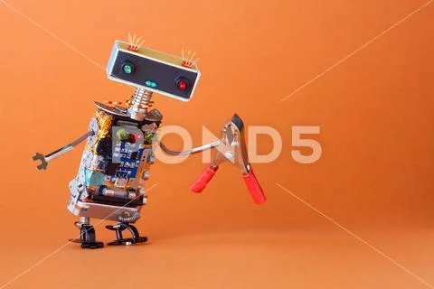 Service and repairment concept. Abstract robotic toy worker with red pliers. Fun Stock Photos