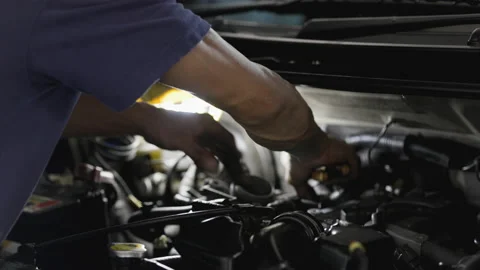 Service Car mechanic use wrenches to repair car In the automotive industry. Stock Footage 146444101