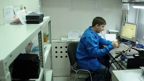 Service center. Electronics repair shops. The repair of the smartphone. Man Stock Footage 82762037