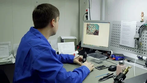 Service center. Electronics repair shops. The repair of the smartphone. Man Stock Footage 82765723