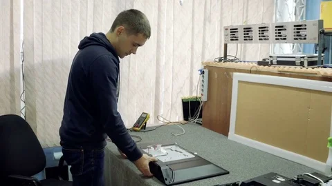 Service center. Electronics repair shops. The man is repairing the TV. Stock Footage 82813165