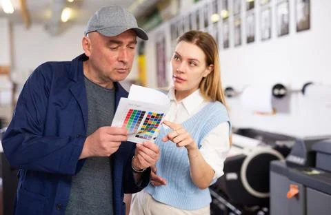 Service engineer and office worker checking color chart test page together Stock Photos