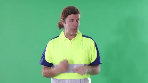 Service engineer in a reflective polo stands and gives a briefing on a green Stock Footage 344847865