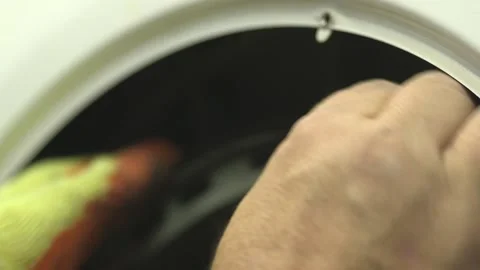 Service engineer testing and repairing a washing machine. Close up of male Stock Footage 146806548