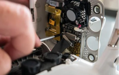 Service man working at drones chipboard with screwdriver Stock Photos