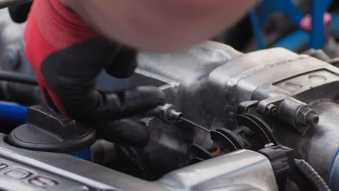 Service man works in the engine compartment in red dielectric work gloves Stock Footage 128494609