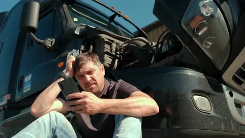 Service, mechanic. The despair the driver is talking by phone about the problem Stock Footage 156172339