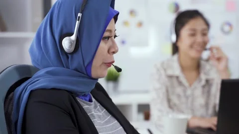Service representative wearing headset is smiling Stock Footage 149074661