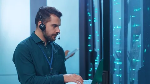 Service support technician inspecting open internet rack server working on Stock Footage 119842204
