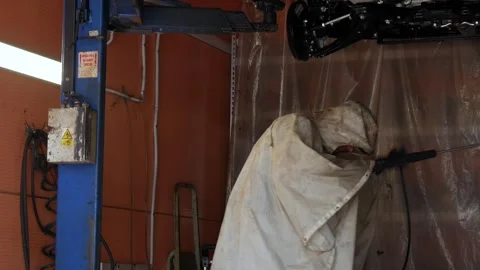 A service worker in overalls completes the car washing process. Stock Footage 248166963