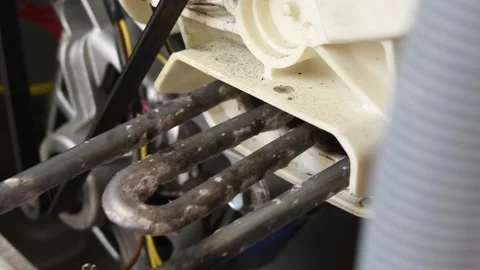 Service Worker pulls out the heating element of a washing machine. Washing .. Stock Footage 287297886