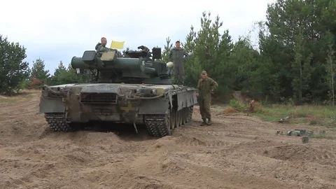 Serviceman near their tanks during the Ukrainian Army exercises on the field. Video stock 80367171