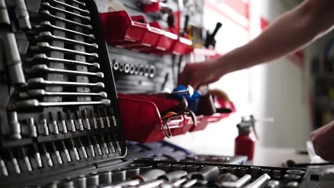 Serviceman Putting All Tools And Wrencher In Their Places On A Mechanic's Shelf Stock Footage 341574299