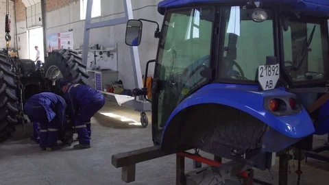 Serviceman Repairs Tractor Gear Box and Engine Stock Footage 73714816
