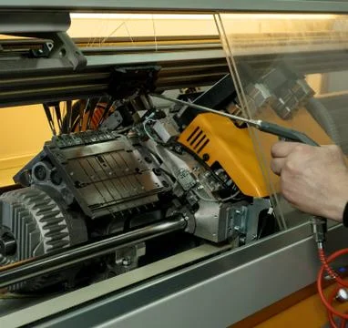 Serviceman setting up the knitting machine shot Stock Photos