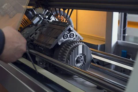 Serviceman setting up the machine at knitting shop Serviceman setting up t... Stock Photos