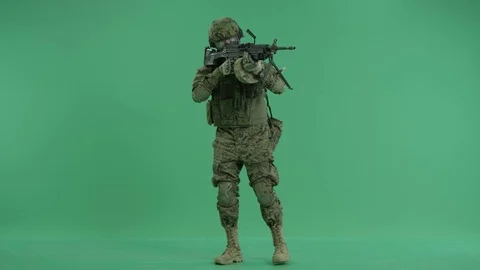 Serviceman standing and targeting around at green screen Stock Footage 70404676