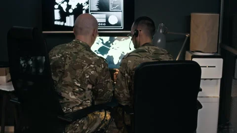 Servicemen Observing Map of Supplies in Command Hub Video stock 301671631
