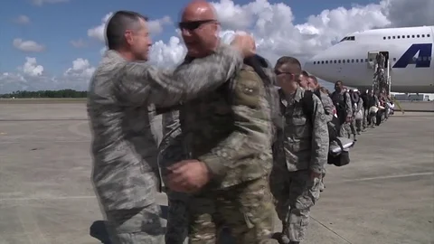 Servicemen welcomed on safe return from deployment Stock Footage 90164561