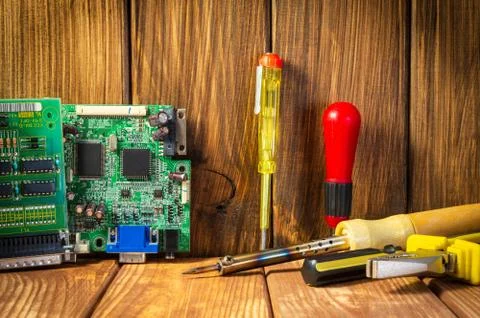 Services and repair of electronics, electronic boards. Wooden background Stock Photos