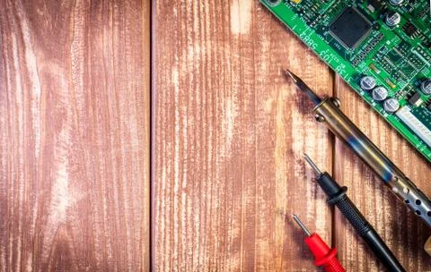 Services and repair of electronics, electronic boards. Wooden background Stock Photos