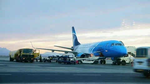 Servicing a passenger aircraft at the airport, loading baggage to the airplane Stock Footage
