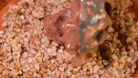 Serving of appetizing dish on table. Buckwheat, goulash with dill in plate. Stock Footage 248180963