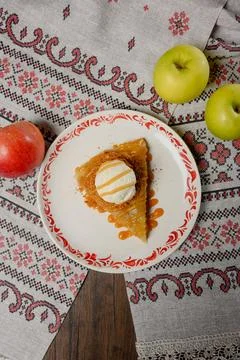 A serving of apple pie with vanilla ice cream on a plate. Stock Photos