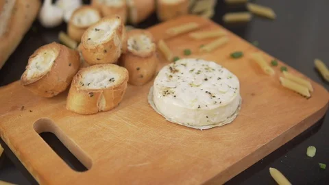 Serving baked Camembert cheese with garlic and croutons . Camembert with garlic 스톡 동영상 91200577