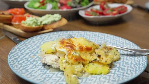 Serving of baked potatoes with meat on dinner table. Stock Footage 254660024