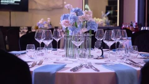 Serving a beautiful wedding table with a bouquet of flowers in the center. Stock Footage 248133206