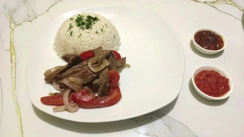 Serving of beef, rice and potatoes called "Lomo saltado". Typical food in Peru. Stock Footage 291914223