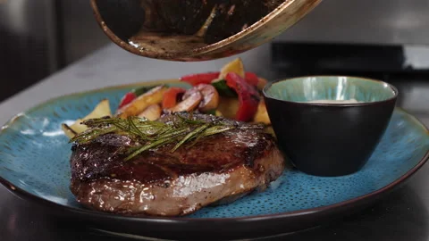 Serving a beef steak fried with rosemary and butter - close-up Stock-Footage 154894957