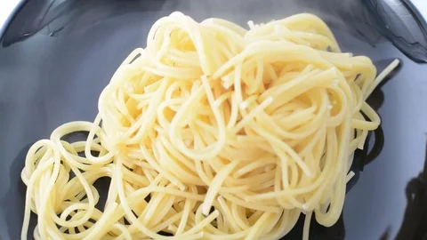 Serving boiled spaghetti on black plate Stock Footage 74492721
