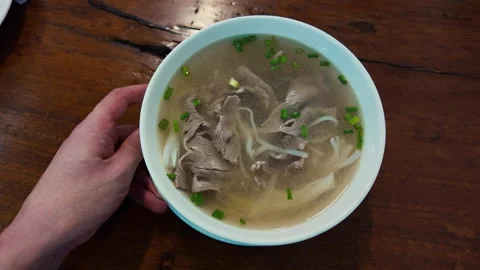 Serving bowl of hot vietnamese pho soup Stock Footage 336087488