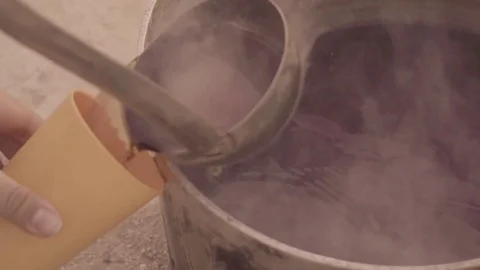 Serving campfire tea into cup Stock Footage 82232100