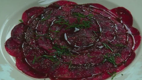 Serving carpaccio meat dish with parmesan cheese slow motion сlose up HD video Stock Footage 70007521