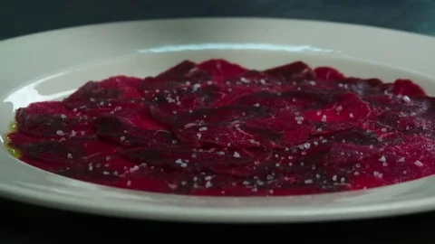 Serving carpaccio meat dish with pepper HD slow motion сlose up HD video Stock Footage 70006923
